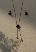 Gold stainless steel necklace with black clover pendant and matching stud earrings