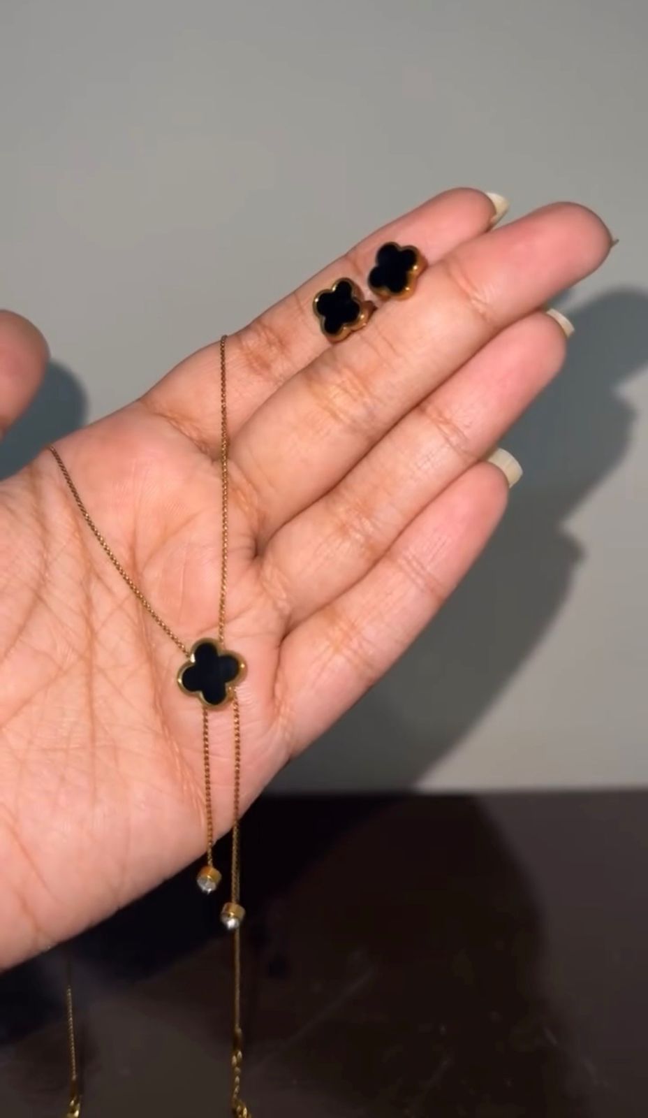 Gold stainless steel necklace with black clover pendant and matching stud earrings