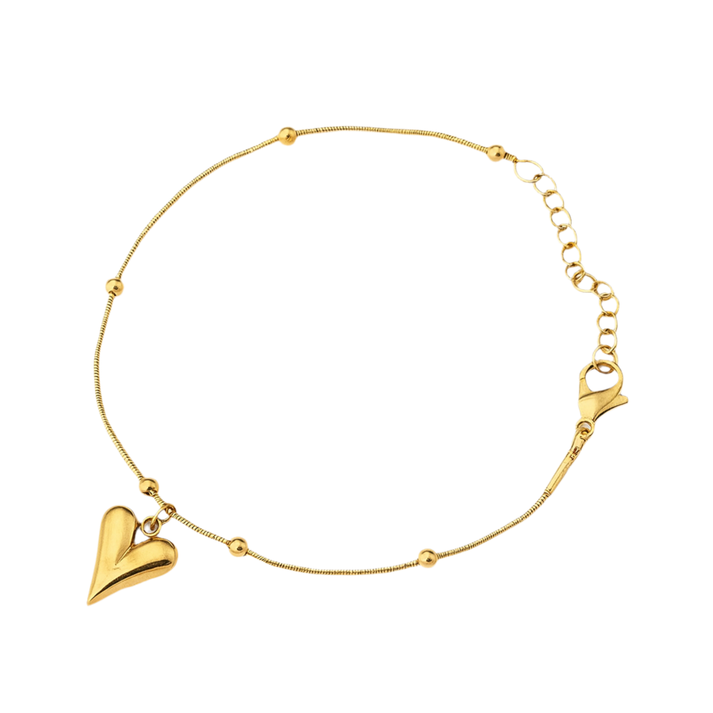 Gold heart pendant necklace on textured cream background, stainless steel jewelry for women
