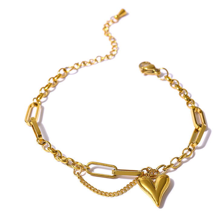 Gold stainless steel chain bracelet with heart charm and mixed link design on white background